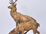 bronze sculpture of a deer and a baby deer on a rock