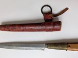 two different types of knives on a white surface