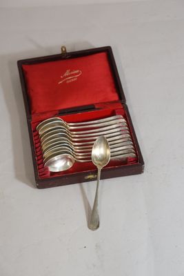 a box of silver spoons and spoons on a table
