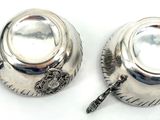 pair of silver plated sugar and pepper shakers with spoons