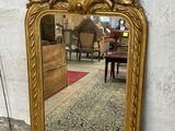 a mirror that is sitting on the ground in front of a wall