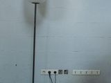 a lamp that is sitting on the floor next to a wall