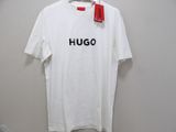 white t - shirt with the word hugo on it hanging on a hanger