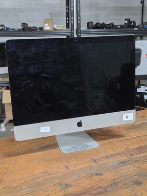 a computer monitor sitting on top of a wooden table