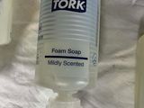 a bottle of foam soap next to a bottle of soap