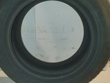 tire on the floor of a garage with a white wall