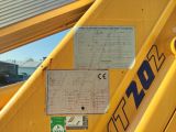 a sign on the back of a yellow construction vehicle