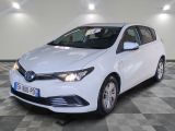 La Toyota Corolla blanche est garée dans une grande pièce.