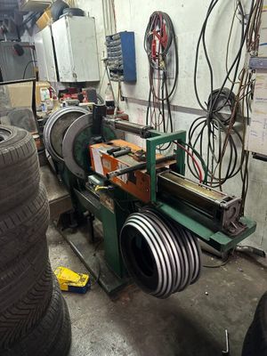 a machine that is working on a tire in a garage