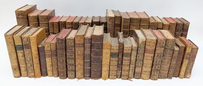 a lot of old books stacked on top of each other