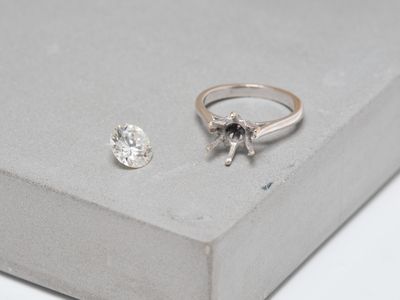 a diamond and a silver ring sitting on top of a box