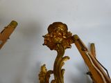 a gold clock on the wall next to a pair of scissors