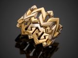 a close up of a gold ring on a black surface