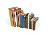 several books are stacked on top of each other on a white surface