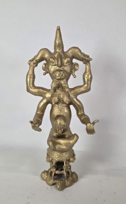 an image of a gold statue of a man holding a snake