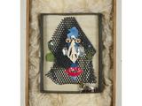 an image of a framed picture of a woman with a blue hat