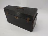 a black box with a handle on a white surface