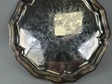 a silver plate with a design on it on a table