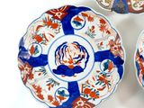 three plates with different designs on them sitting on a white surface