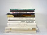 many books stacked on top of each other on a table