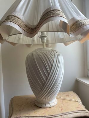 a lamp that is sitting on a table near a window