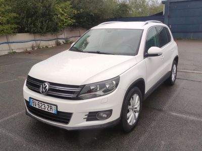 the white volkswagen suv is parked in the parking lot