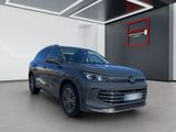a grey volkswagen suv parked in a showroom