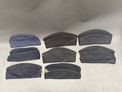 six pairs of hats are lined up in a row on a table