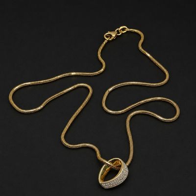 a gold and diamond necklace on a black background