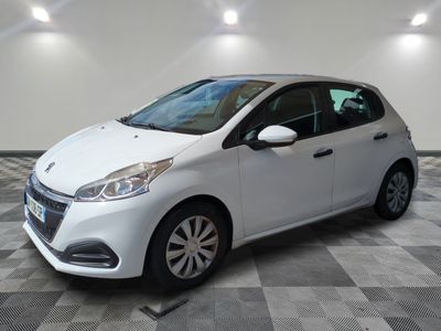 the small white car is parked in a large room