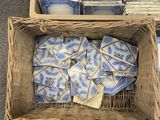 two baskets filled with blue and white dishes sitting on top of a carpet