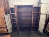 a large wooden bookcase in the middle of a room