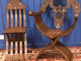 two wooden chairs sitting on a rug in a room