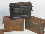 three old metal boxes are stacked on top of each other