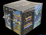 a close up of a box of pokemon trading cards on a black background