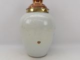 an image of a white vase with a gold lid sitting on a white surface