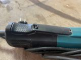 a blue and black corded electric tool on a table