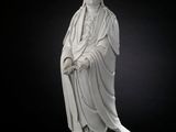 an image of a statue of a woman sitting on top of a rock