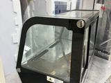 a microwave oven sitting on a counter in a store