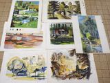 many pictures of watercolor paintings on the floor