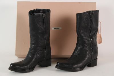 black leather cowboy boots with zippers on the side and a box