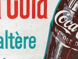 a coca cola sign on the side of a building