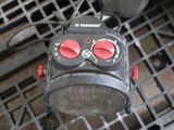 a small radio sitting on top of a metal grate