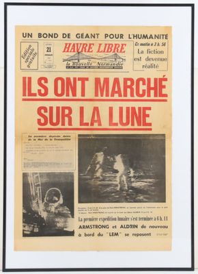 a newspaper with a picture of a man on a surfboard in the water