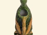 a ceramic vase with a bird on top of it