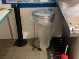 a trash can and a trash can in a public restroom