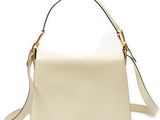 a white handbag with a gold handle on a white background