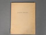 the book is open on a gray surface with a black background