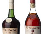 two bottles of liquor sit next to each other on a white surface