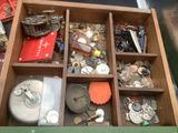 a wooden box filled with assorted items on a table